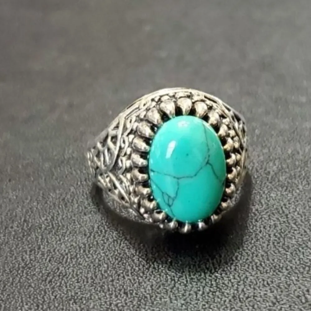 Silver tone ring with blue stone approx 11